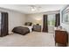 Neutral bedroom featuring carpet, ceiling fan, and window overlooking outdoors at 2610 Ginger Dr, Buford, GA 30519
