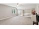 Bright bedroom featuring built-in bookshelves, carpet, and natural light at 2610 Ginger Dr, Buford, GA 30519