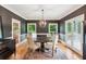 Dining room with dark walls, hardwood floors, a round table, and windows providing natural light at 2610 Ginger Dr, Buford, GA 30519