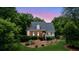 Charming brick home with a inviting front porch and lush, mature landscaping at 2610 Ginger Dr, Buford, GA 30519