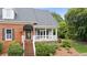 Close-up of the home's brick facade, black awning, and inviting front porch entrance at 2610 Ginger Dr, Buford, GA 30519