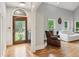 Welcoming foyer with hardwood floors, a decorative glass front door, and an open archway to the living area at 2610 Ginger Dr, Buford, GA 30519