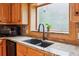 Close-up of kitchen granite counters and sink with a window to the yard at 2610 Ginger Dr, Buford, GA 30519