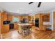 A spacious kitchen featuring granite counters, wood cabinets and an island with cooktop at 2610 Ginger Dr, Buford, GA 30519