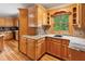 A spacious kitchen with wood cabinets, granite counters, hardwood floors at 2610 Ginger Dr, Buford, GA 30519
