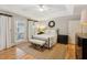 A bright main bedroom with a tray ceiling, hardwood floors, and balcony access at 2610 Ginger Dr, Buford, GA 30519