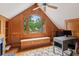 Office with wood paneling, built-in bench, window view, desk, and patterned rug at 2610 Ginger Dr, Buford, GA 30519