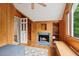 Office with wood paneling, window view, built-in bookshelves and storage, and fireplace at 2610 Ginger Dr, Buford, GA 30519