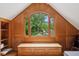 Office with wood paneling, built-in bench, window view, desk, and patterned rug at 2610 Ginger Dr, Buford, GA 30519