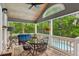 Screened-in porch with seating, a table, and a view of the pool and outdoors at 2610 Ginger Dr, Buford, GA 30519