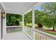 Covered porch with white railings and columns, offering a peaceful outdoor space at 2610 Ginger Dr, Buford, GA 30519