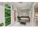 Bright sunroom with tile floors, large windows overlooking green trees, and a cozy seating area at 2610 Ginger Dr, Buford, GA 30519