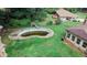 Backyard showcasing a swimming pool surrounded by well-maintained lawn and mature trees at 3257 Georgian Woods Cir, Decatur, GA 30034