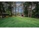 Spacious backyard with tall trees and a shed, offering ample outdoor space at 3257 Georgian Woods Cir, Decatur, GA 30034