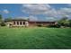 Large backyard featuring a grassy lawn, patio area, and a detached sunroom or additional living space at 3257 Georgian Woods Cir, Decatur, GA 30034