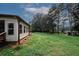 Spacious backyard with a large grassy area and mature trees, perfect for outdoor activities at 3257 Georgian Woods Cir, Decatur, GA 30034