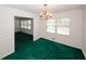 Cozy dining room includes a charming chandelier and bright green carpeting at 3257 Georgian Woods Cir, Decatur, GA 30034