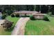 Lovely one-story home with a beautiful stone facade and a long driveway at 3257 Georgian Woods Cir, Decatur, GA 30034