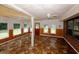 Sun room with wood paneled lower walls, neutral upper walls, and patterned tile floors at 3257 Georgian Woods Cir, Decatur, GA 30034