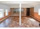 Sun room with wood paneled lower walls, neutral upper walls, and patterned tile floors at 3257 Georgian Woods Cir, Decatur, GA 30034