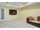 Basement living area with carpeted floors and flat screen television at 5004 Duxford Se Dr, Smyrna, GA 30082
