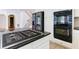 Kitchen island with black granite countertop and stainless steel gas cooktop at 5004 Duxford Se Dr, Smyrna, GA 30082