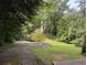 Long driveway leading to property with mature trees and lush greenery providing shade and privacy at 998 Northrope Ne Dr, Atlanta, GA 30324