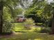 Two-story home with a red deck surrounded by lush greenery and a well-maintained lawn at 998 Northrope Ne Dr, Atlanta, GA 30324