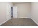 This bedroom is cozy and bright with neutral paint, base molding, plush carpet, and a closet at 1760 Spring Ave, Atlanta, GA 30344