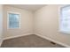 Bright bedroom featuring neutral walls, base molding, blinds, and carpet at 1760 Spring Ave, Atlanta, GA 30344