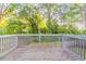 Outdoor wooden deck with gray railings offering a great view of the backyard and surrounding landscape, perfect for entertaining at 1760 Spring Ave, Atlanta, GA 30344