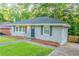 Charming single-story home with a well-maintained lawn and a dark-colored front door at 1760 Spring Ave, Atlanta, GA 30344