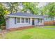 Well-maintained single-story home with a green lawn, dark shutters and matching front door at 1760 Spring Ave, Atlanta, GA 30344