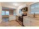 Bright kitchen featuring stainless steel appliances, white cabinets and stone countertops at 1760 Spring Ave, Atlanta, GA 30344