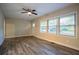 Inviting living room with wood-look floors, ceiling fan, and natural light from large windows at 1760 Spring Ave, Atlanta, GA 30344