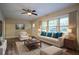 Bright living room with wood floors, a ceiling fan, and a comfortable seating arrangement with backyard view at 1760 Spring Ave, Atlanta, GA 30344