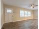 Bright living room with wood-look flooring, a white front door and ample natural light at 1760 Spring Ave, Atlanta, GA 30344