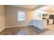 Bright living room featuring wood-look flooring and a window view to the kitchen area at 1760 Spring Ave, Atlanta, GA 30344