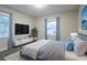 This main bedroom is complete with plush carpet, stylish decor, and large windows at 1760 Spring Ave, Atlanta, GA 30344