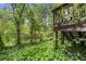 Backyard featuring mature trees and an elevated deck at 2501 Northbrook Rd, Snellville, GA 30039