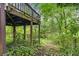 Backyard featuring mature trees and an elevated deck at 2501 Northbrook Rd, Snellville, GA 30039