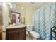 Bathroom with patterned shower curtain, vanity with granite top, and neutral wall paint at 2501 Northbrook Rd, Snellville, GA 30039