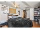Bedroom featuring wood-look floors, a ceiling fan, and lots of book storage at 2501 Northbrook Rd, Snellville, GA 30039