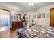 Bedroom featuring hardwood flooring, ceiling fan, and an adjacent bathroom at 2501 Northbrook Rd, Snellville, GA 30039