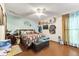 Bedroom features ceiling fan, hardwood flooring, and a bright window illuminating the space at 2501 Northbrook Rd, Snellville, GA 30039