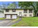Charming split-level home featuring a two-car garage and front yard at 2501 Northbrook Rd, Snellville, GA 30039