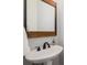 Elegant bathroom with pedestal sink, decorative mirror, and bronze faucet at 1143 Brookhaven North Cir, Brookhaven, GA 30319