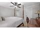 A bedroom featuring a four-poster bed, ceiling fan, neutral color scheme, carpet flooring, and a desk for a functional space at 1143 Brookhaven North Cir, Brookhaven, GA 30319