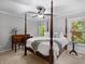 A bedroom with a four-poster bed, ceiling fan, a side table with lamp, neutral color scheme, and carpet flooring throughout at 1143 Brookhaven North Cir, Brookhaven, GA 30319