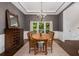 Traditional dining room with rustic wood table, chandelier, and ample natural light at 1143 Brookhaven North Cir, Brookhaven, GA 30319
